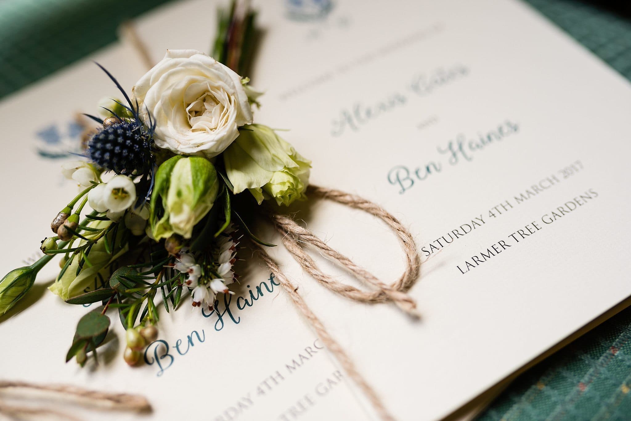 Stunning buttonhole on Larmer Tree Garden Wedding stationery