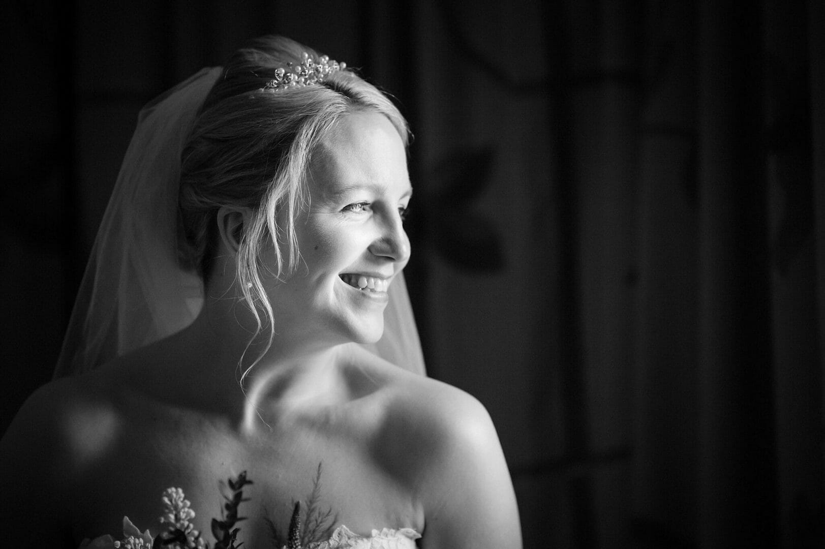Bride looking out the window during her Larmertree wedding