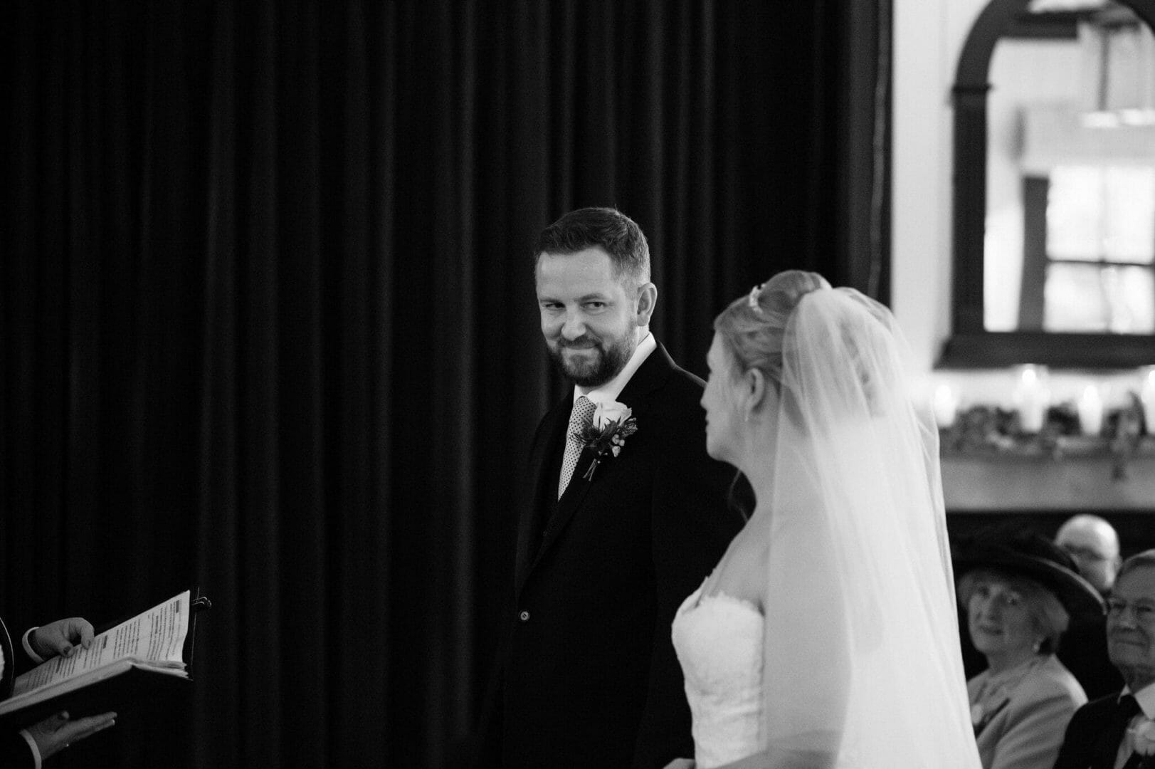 Larmertree garden wedding 36 A knowing look from the groom to his bride at Larmertree gardens