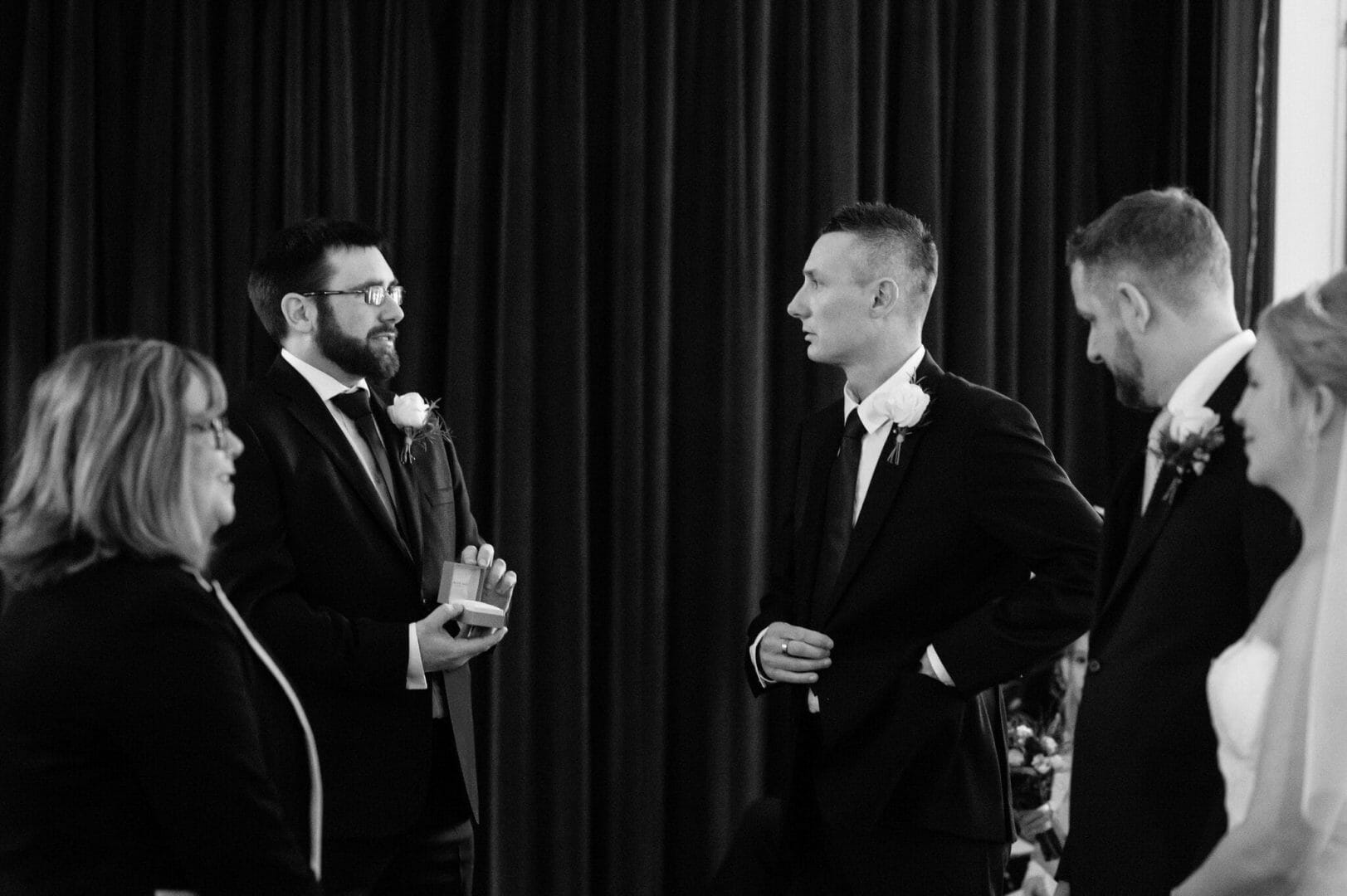 Best man opens an empty ring box during the wedding ceremony