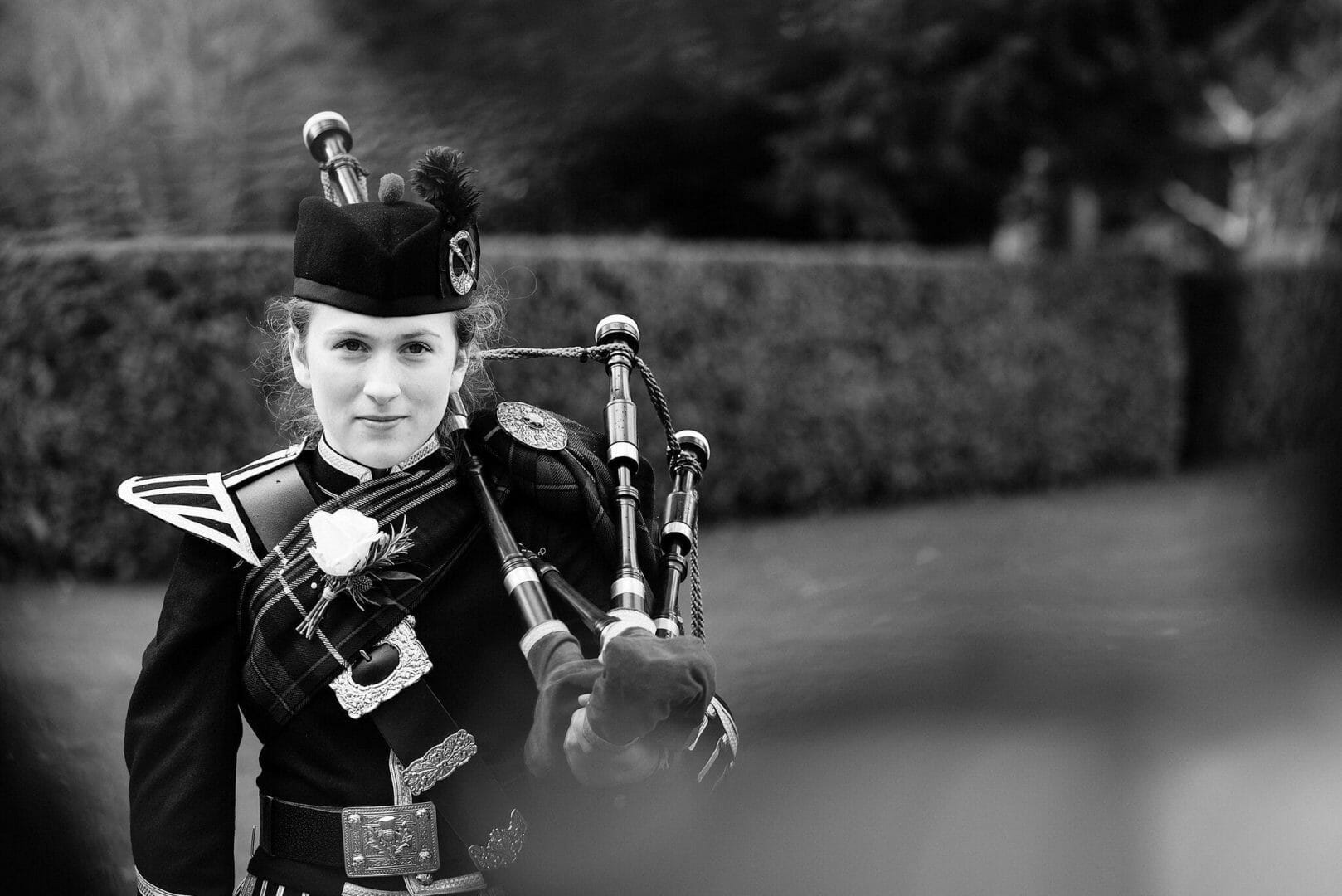 Larmertree garden wedding 56 Piper awaits the bride and groom at Larmertree Gardens