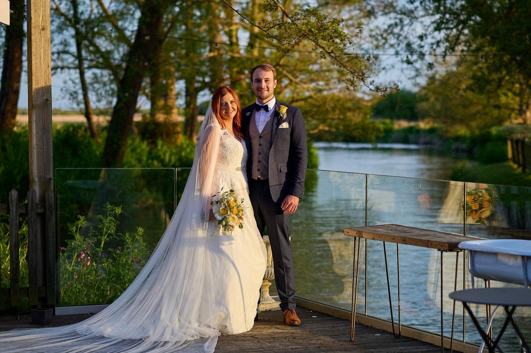 Sopley Mill wedding photographer - Bride and Groom pose by the River