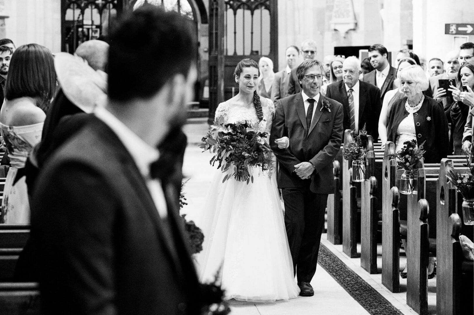 Bride walks the aisle in the Wimborne Minster