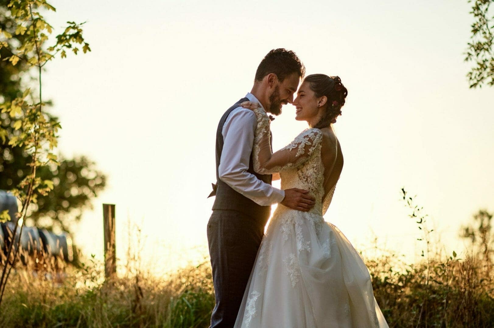Bride and Groom cuddle in the Dorset evening sunshine