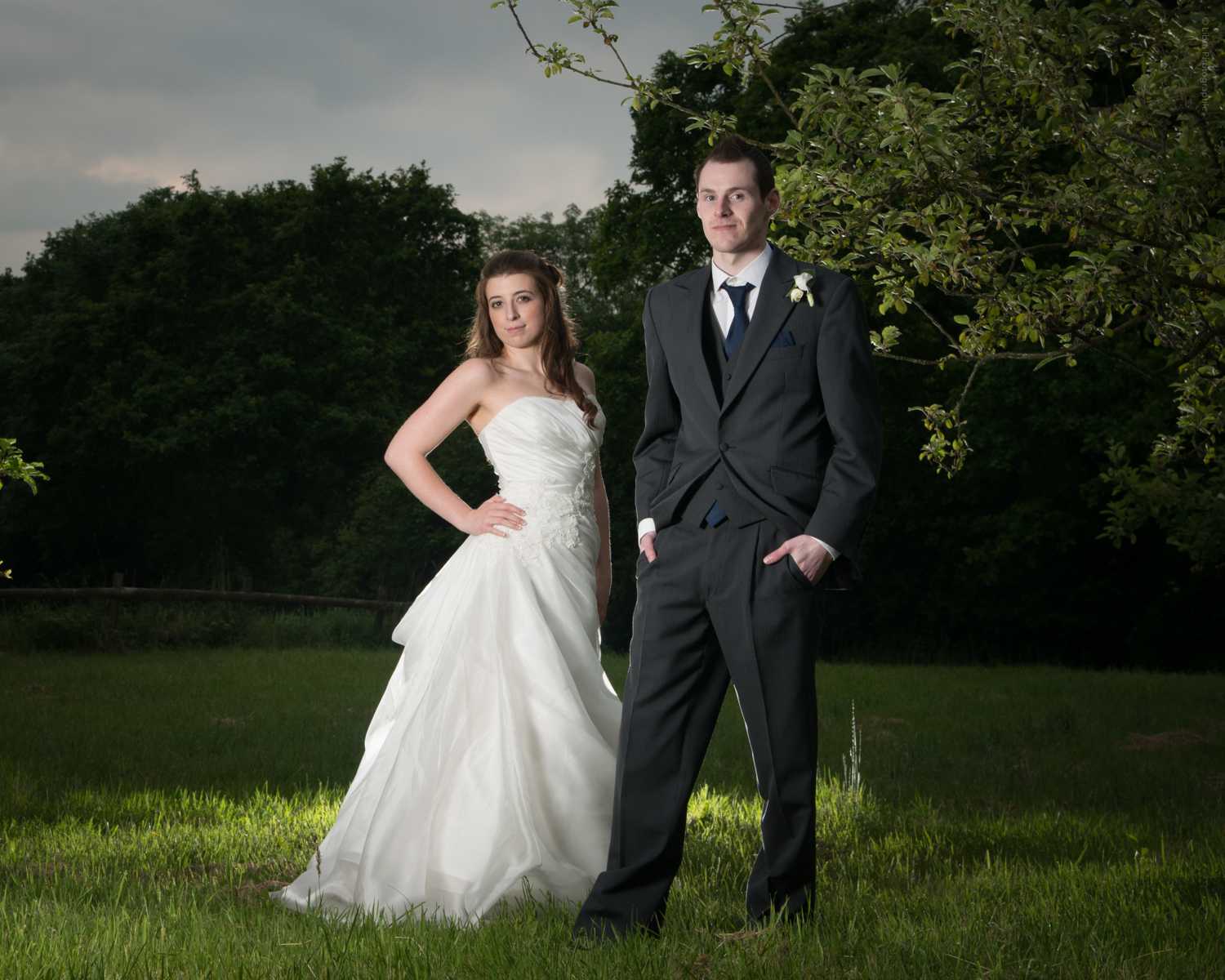 Bride and groom pose in an Orchard near Holt, New Forest