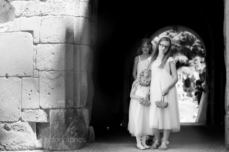 Bridesmaids wait in Old Wardour castle courtyard