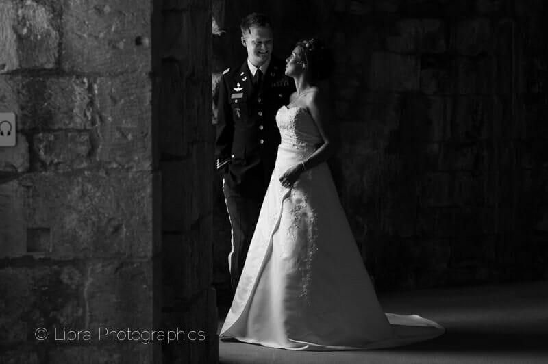 Bride and Groom look from a window at Old wardour castle