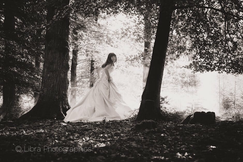 bride running through trees Rhinefield House