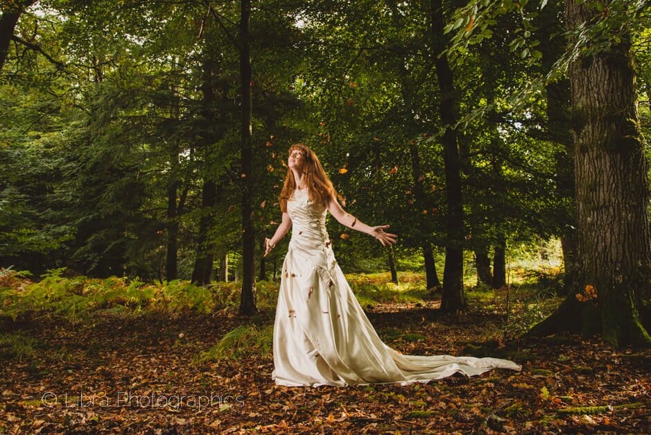 Bride throwing leaves in the air -New Forest wedding