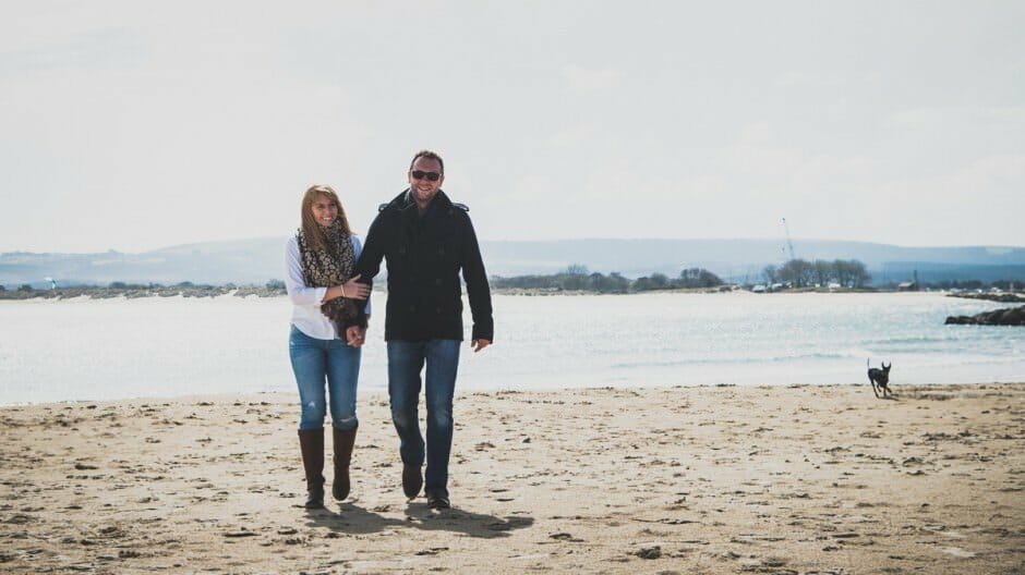 A couple walk along sandbanks beach