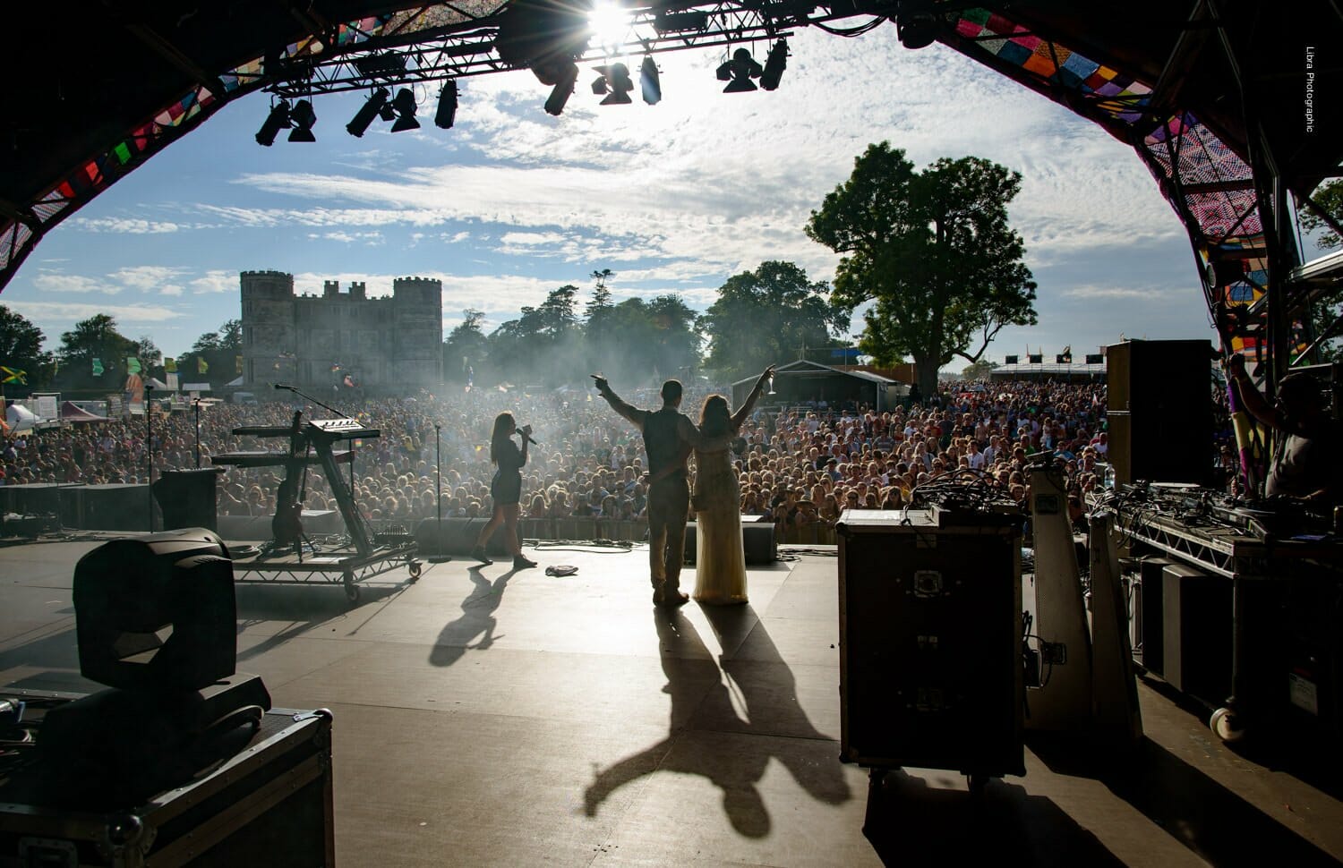 Bride and groom wave to a crowd on Bestival main stage