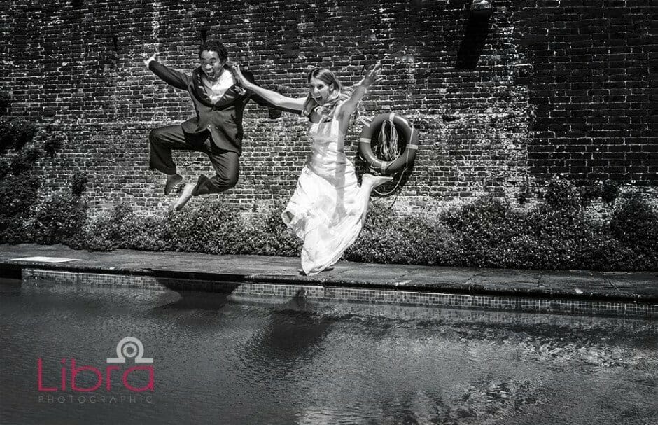 Bride and Groom jump into a swimming pool